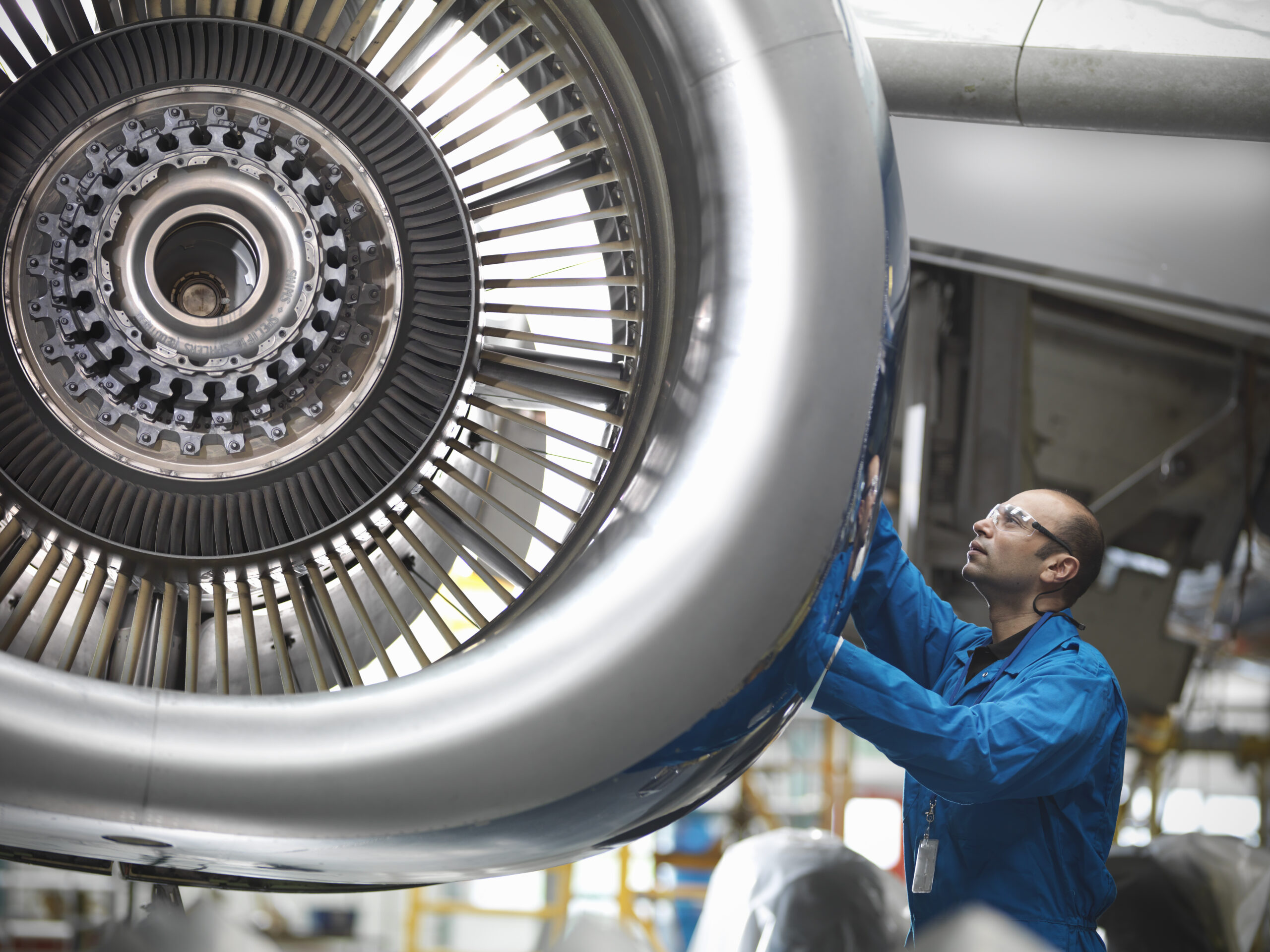 aircraft-engineer-working-on-737-jet-engine-in-airport
